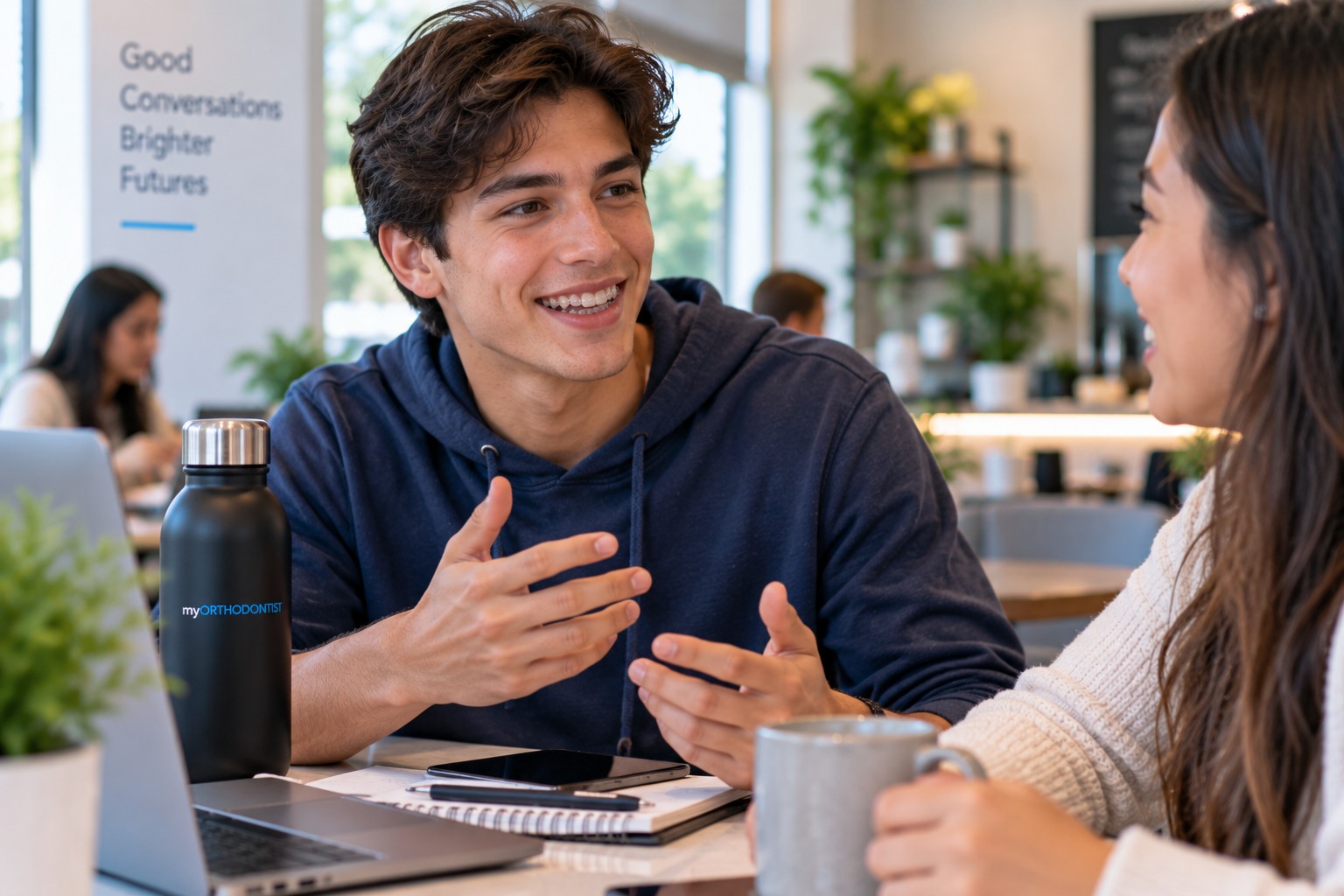 Young adult speaking naturally while adjusting to wearing clear Invisalign aligners